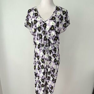 90s inspired purple & white floral jumpsuit w/ V-neckline & elastic waistband